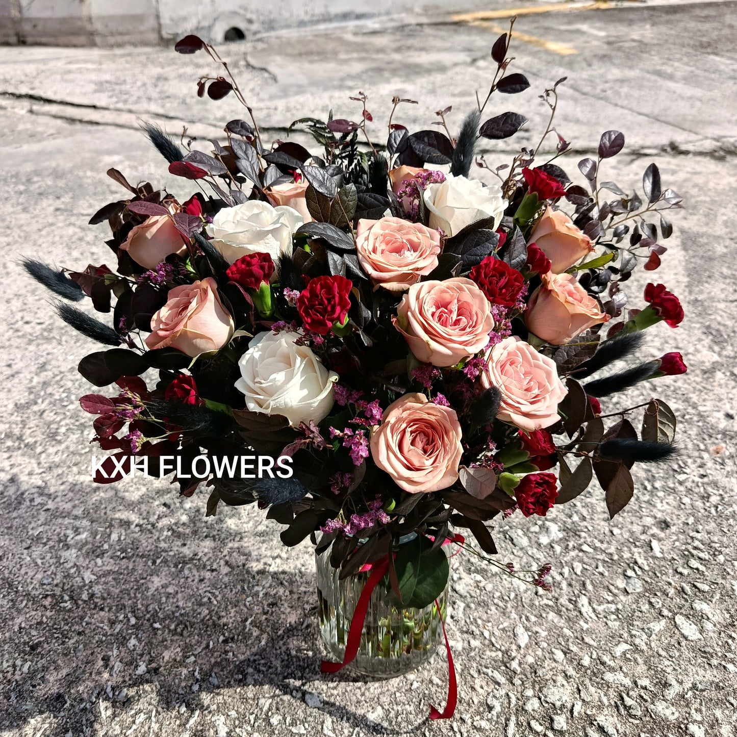 dusty pink brown roses with burgundy foliage and maroon carnations spray singapore florist online