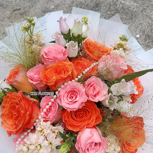 Bouquet of pink and orange roses with white flowers sg florist