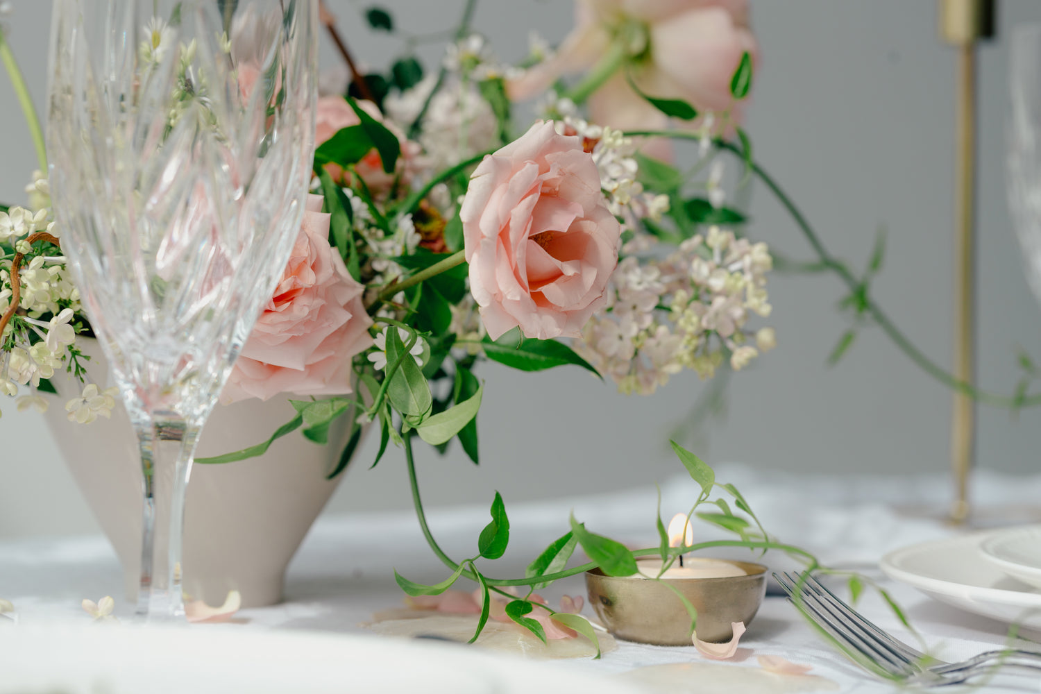 Peach roses arranged on table with glass vase