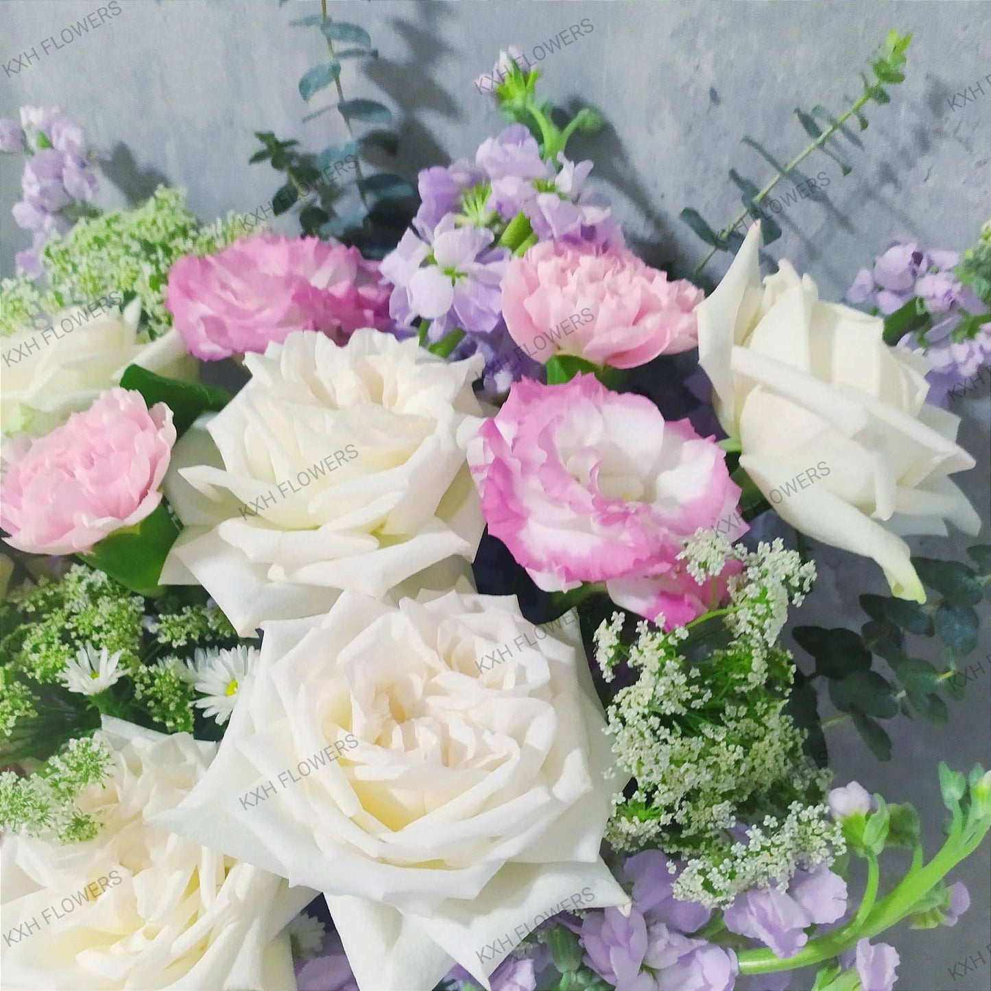 white roses flower arrangement in vase