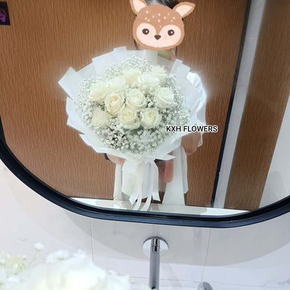 person holding a white roses bouquet singapore florist sg free delivery