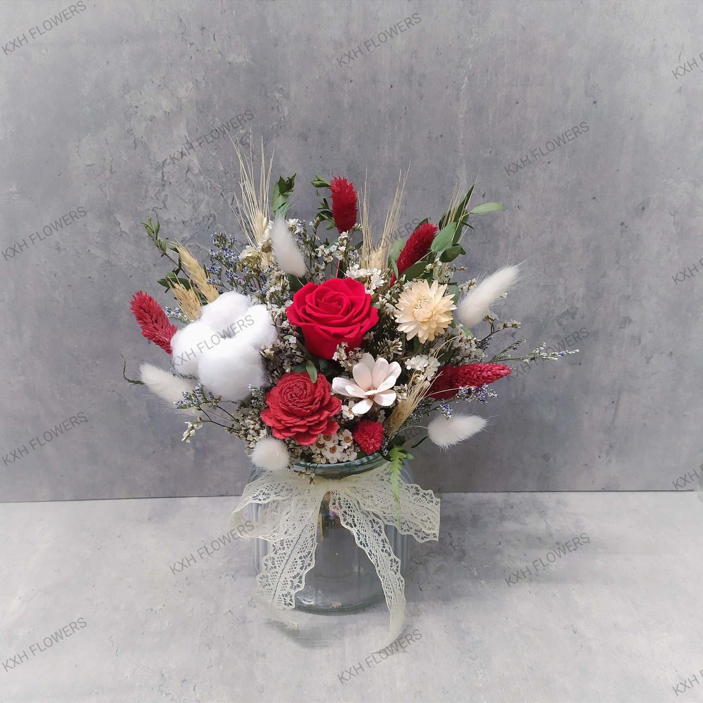 preserved red rose arrangement in clear vase