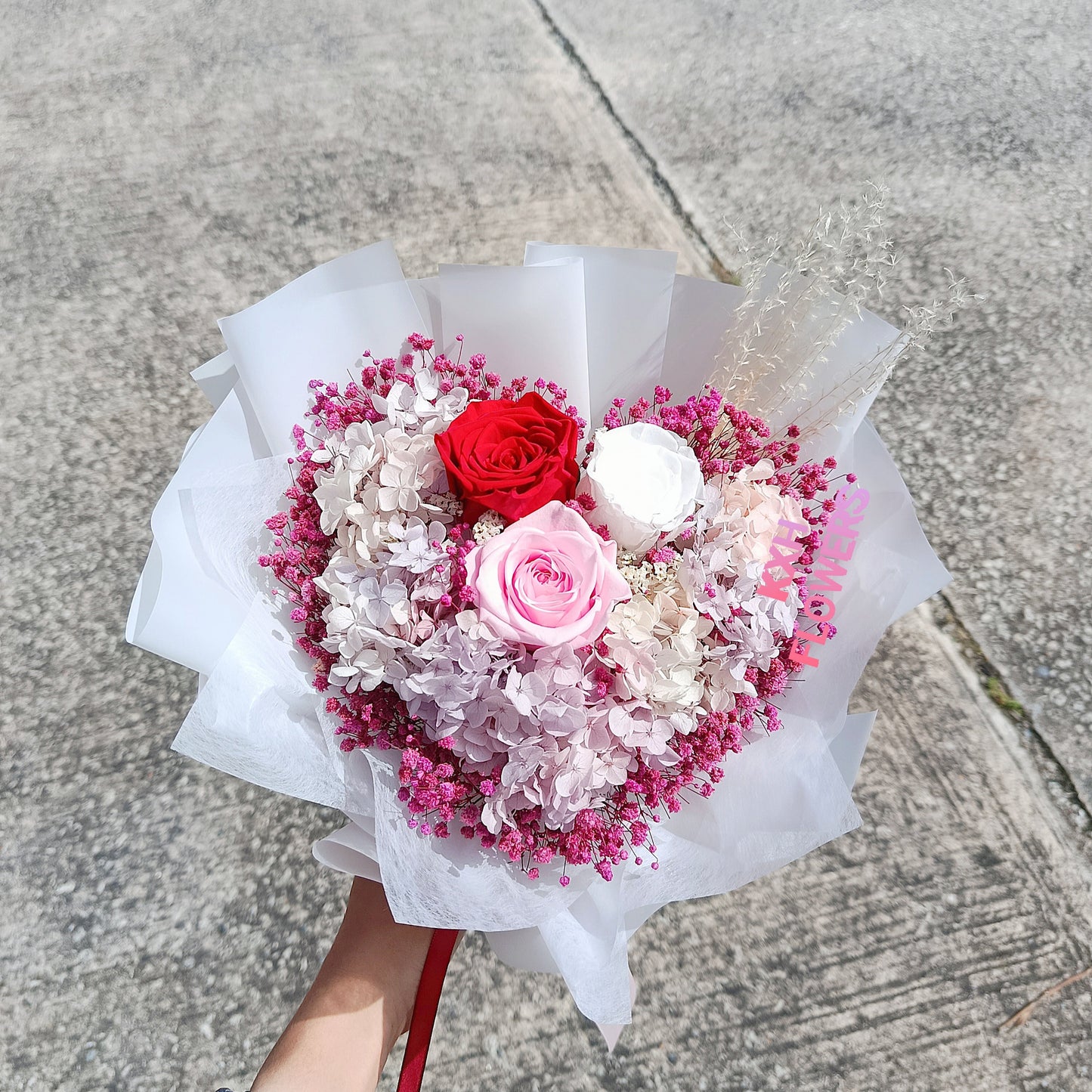 red pink and white preserved roses bouquet in heart shape