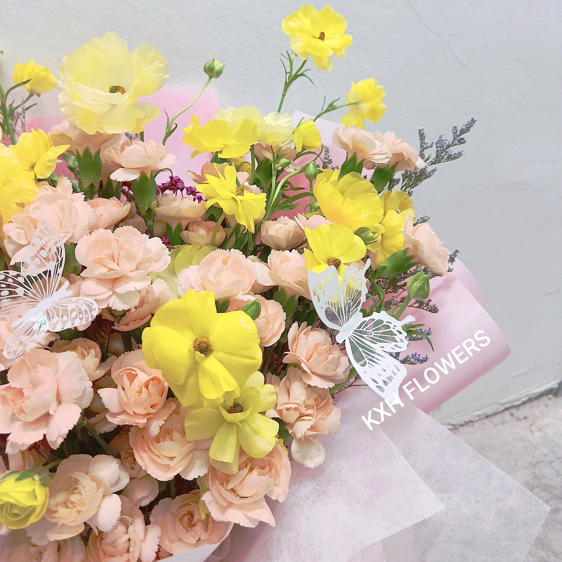 butterfly ranunculus and peach spray carnations
