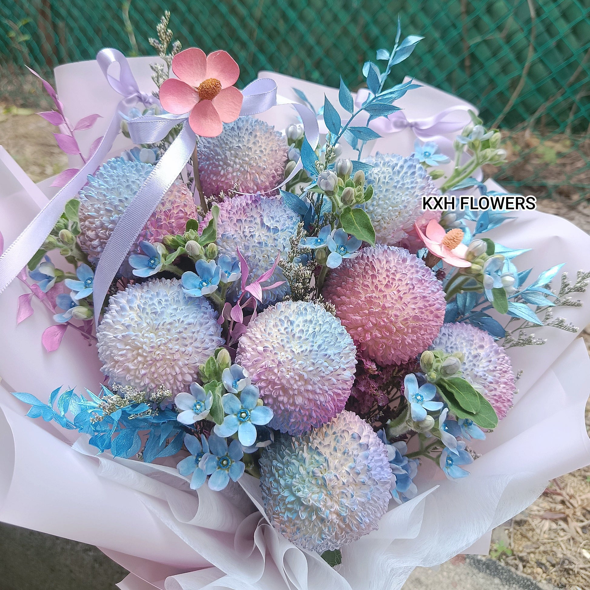 9 ping pong chrysanthemums with blue tweedia and pink wood-crafted daisies sg florist