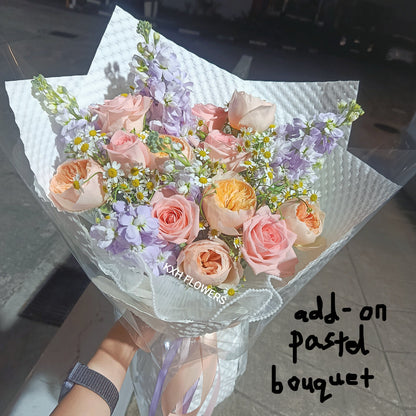 light pink, peach and lilac flowers in white kraft wrapping sg florist singapore flower delivery