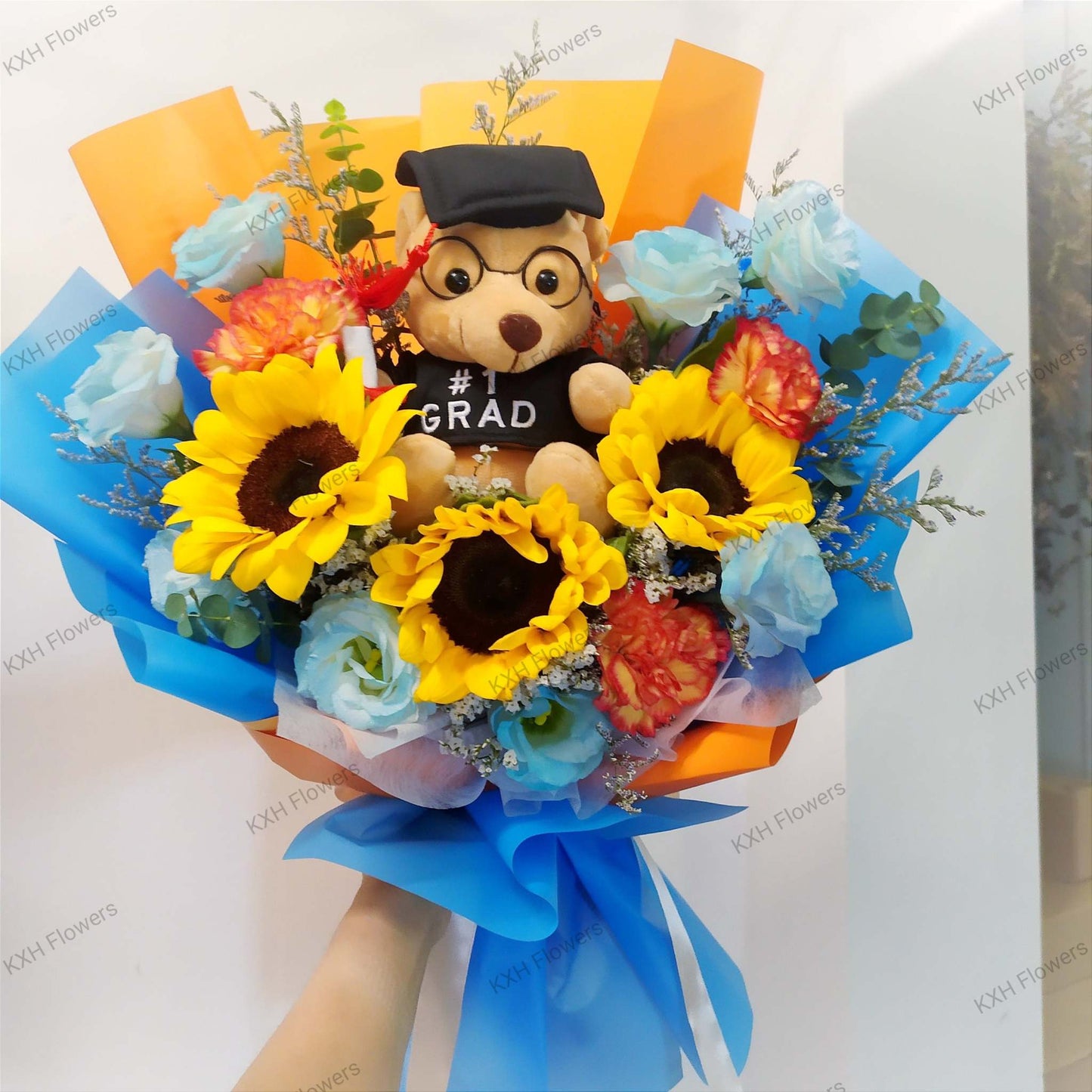 blue and orange grad bear bouquet with sunflowers