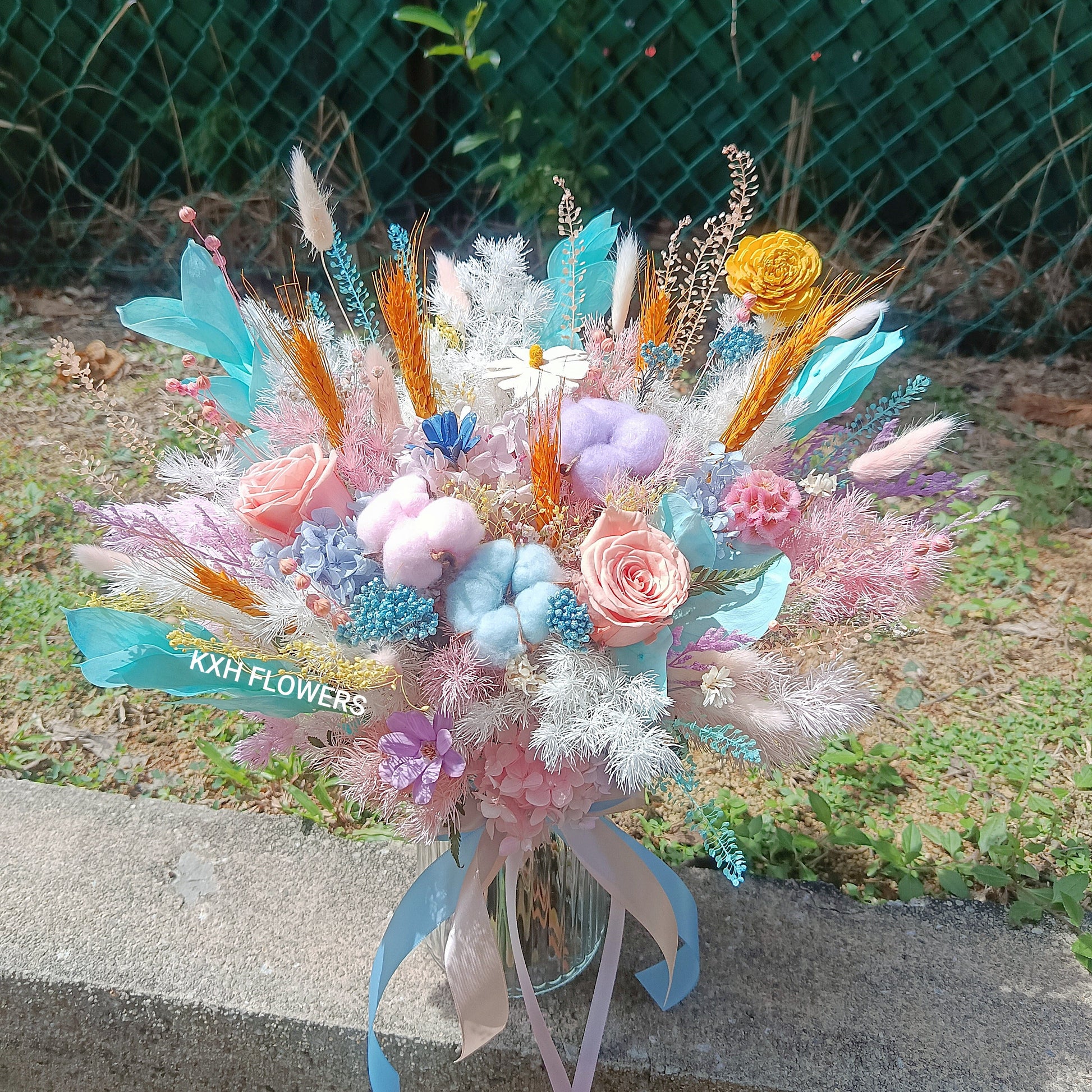 bright pastel preserved flowers in clear vase arrangement singapore florist delivery