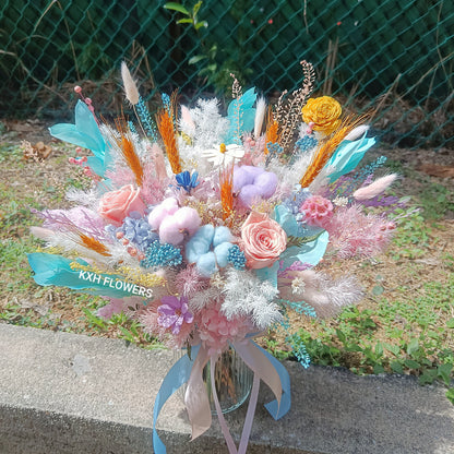 bright pastel preserved flowers in clear vase arrangement singapore florist delivery