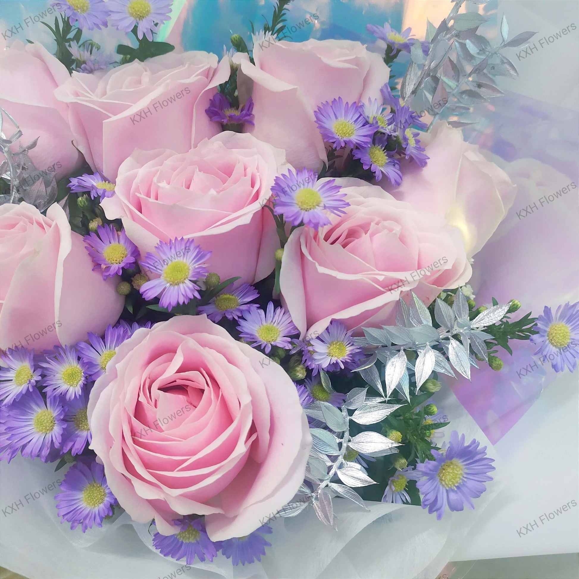 light pink roses purple daisies and silver ruscus