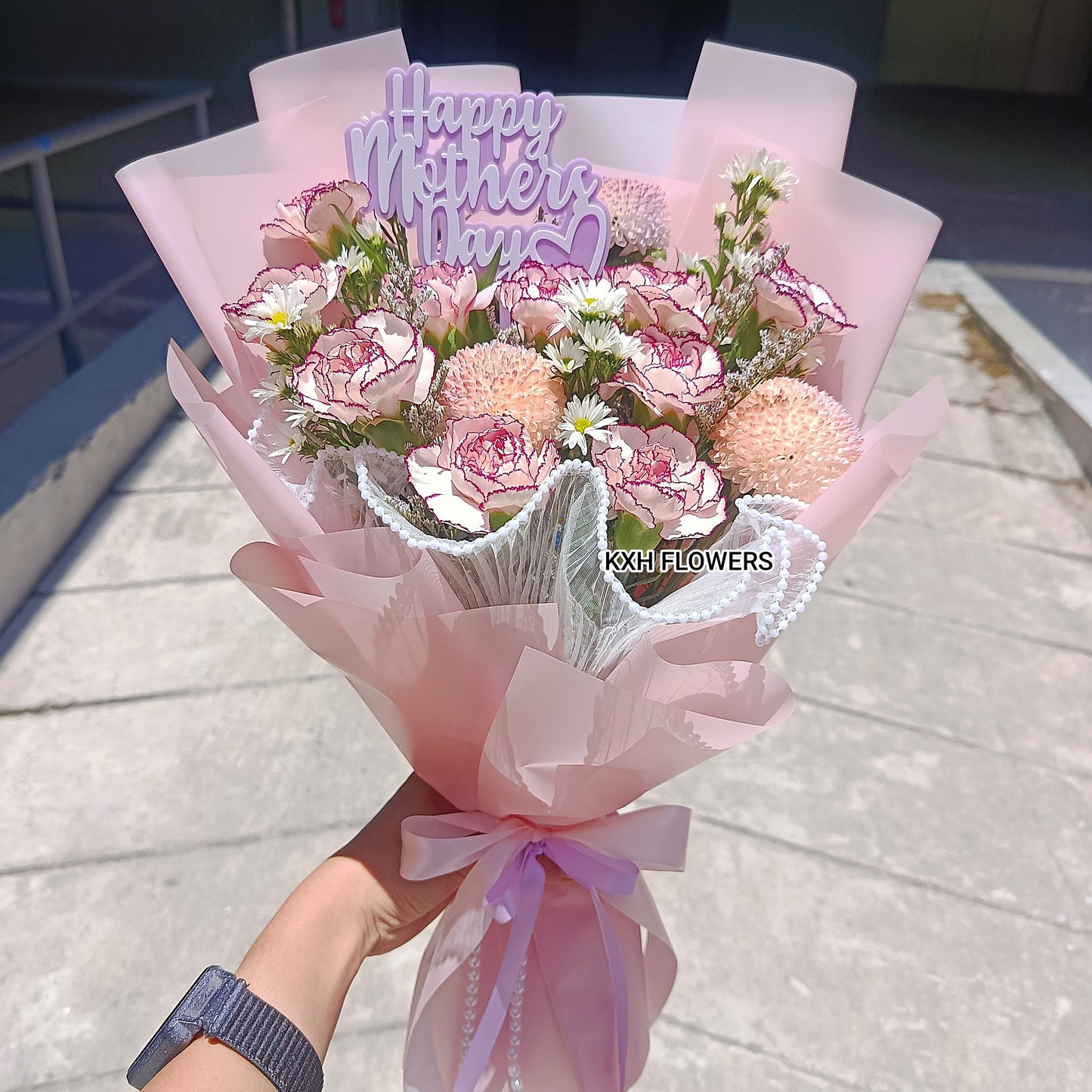 10 purple carnations with mini daisies and "Happy Mother's Day" tag