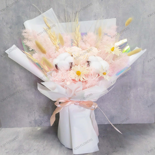 preserved flower bouquet in light peach and pink tones