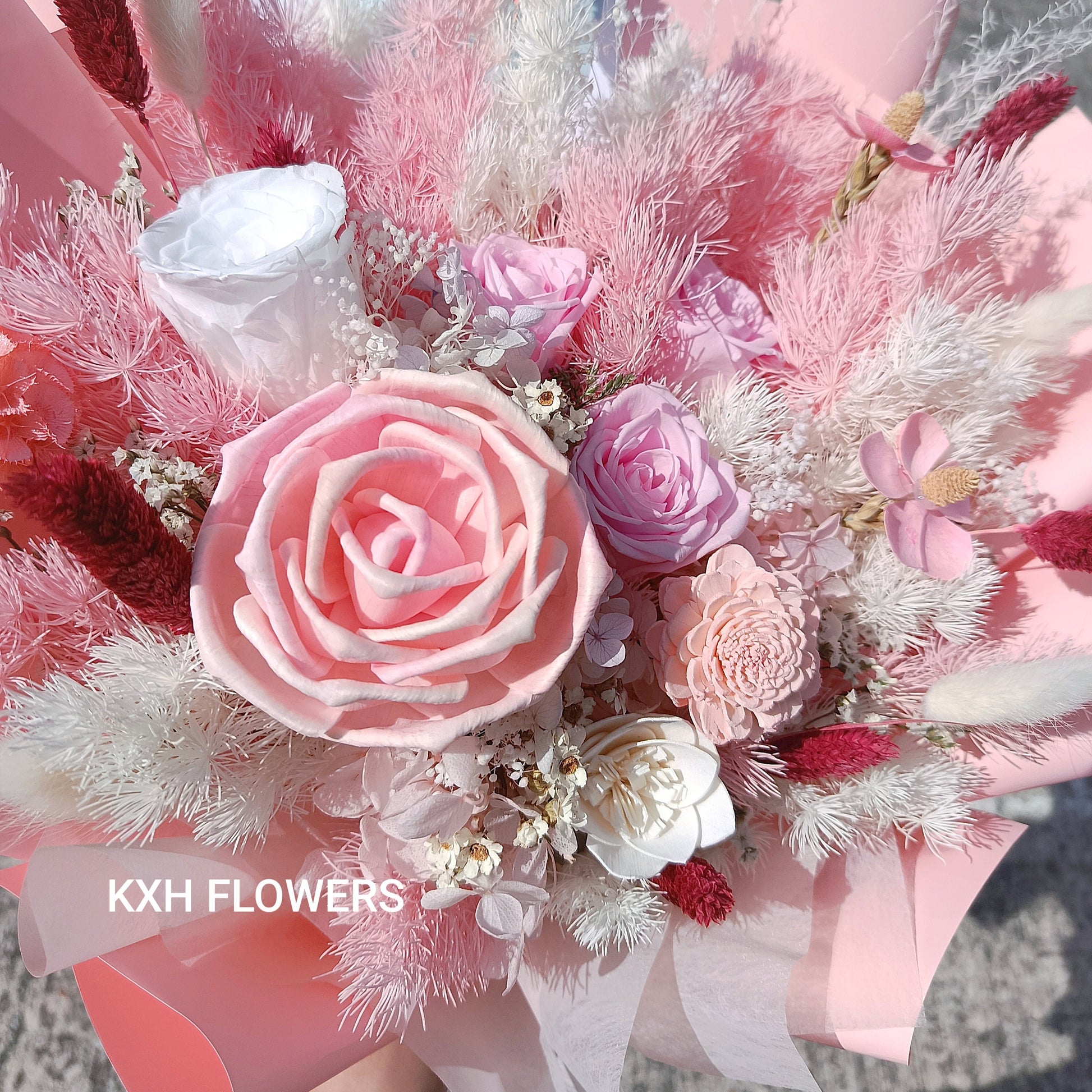 bouquet of 3 pink preserved roses, 1 white preserved rose, premium solawood rose, pink daisies and assorted fillers sg florist