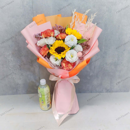 2 sunflowers 4 orange carnations 7 white eustomas graduation bouquet with pink and orange wrapping