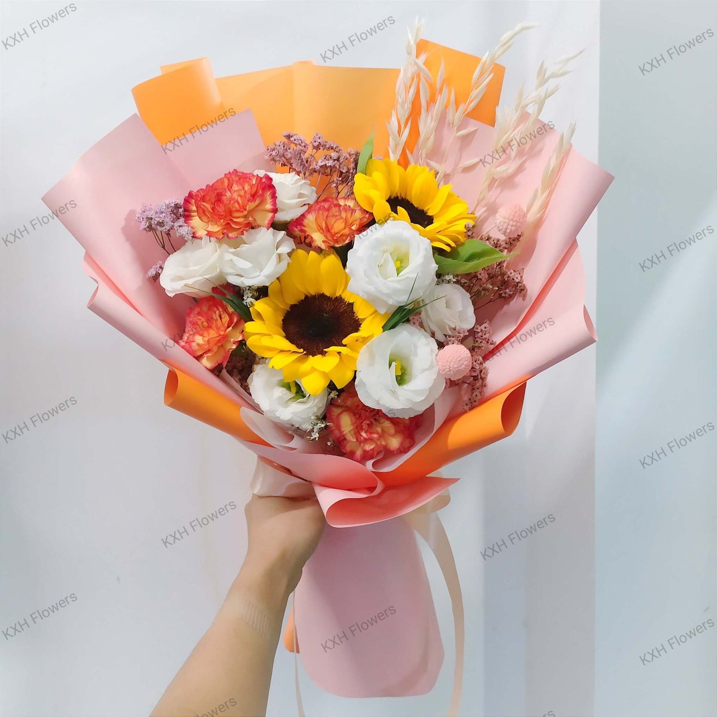 2 sunflowers 4 orange carnations white eustomas pink caspia graduation flowers bouquet